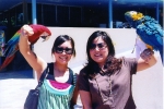 Lauren and Jenny holding parrots